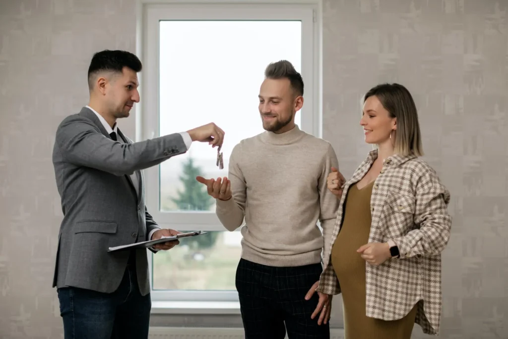 A couple receiving the keys of a house from their landlord